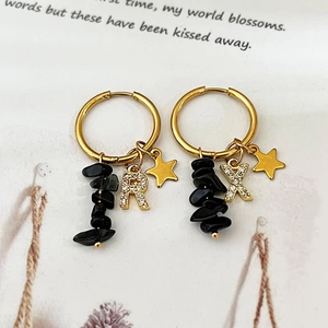 18k gold plated earrings with star pendant and black natural stone on white paper