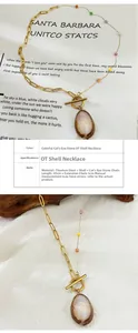 Detailed view of titanium steel chain with OT clasp and natural shell pendant