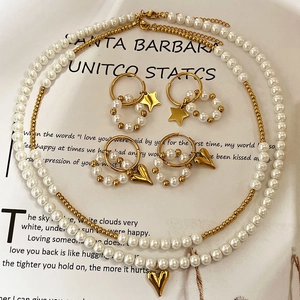 Elegant multi-layer stainless steel necklace set with pearls, golden beads, and heart pendant