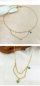 Detail view of 18K gold-plated double-layer necklace with heart turquoise and irregular pendant