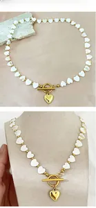 Detail of French heart shell beaded necklace with gold OT buckle and heart pendant