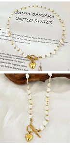 Detail of heart shell beads and golden toggle clasp necklace with heart pendant