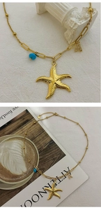 Détail du collier étoile de mer avec lettre A dorée et perle bleue sur chaîne mixte