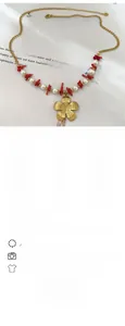 Detail of bohemian gold flower necklace with white pearls and red coral-like beads