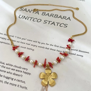 Handmade pearl and red stone beaded necklace with a golden flower pendant for women