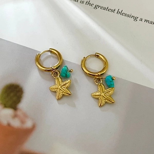 Golden starfish hoop earrings with turquoise stones and a vintage beach ocean theme