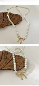 Détail du pendentif nœud papillon doré à l'or 18k sur collier de perles fait main
