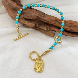 Bohemian turquoise beaded bracelet with gold OT buckle and embossed hand gesture pendant