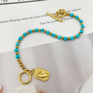 Bohemian blue turquoise beaded bracelet with gold palm pendant and T-bar clasp
