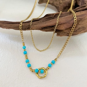 Layered 18K gold-plated stainless steel necklace with blue beads and a circular pendant