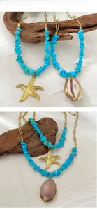 Close-up of bohemian layered necklace with turquoise stones, starfish and seashell charms