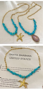 Detail of layered gold necklace with turquoise stones, sea shell, and starfish pendant