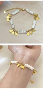 Vue détaillée d'un bracelet étoile en or 18k avec perles de nacre sur soie et poignet