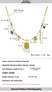 Detail of vintage sun pendant necklace with natural stones and pearl specs
