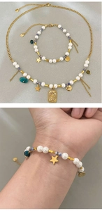 Detail of French vintage necklace with pearls, blue stones and gold sun charms