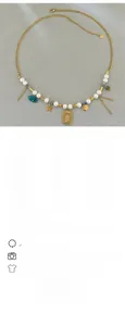 Macro view of French vintage necklace with pearls, purple beads, and gold star charms