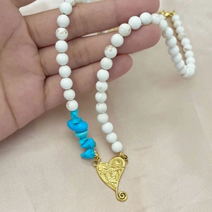 Bohemian beaded necklace with white stones, turquoise accents and golden heart pendant