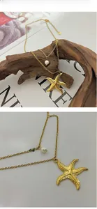 Detail of gold starfish and pearl pendant with a double-layered chain necklace
