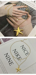 Detailed view of a gold double-layer necklace featuring a starfish pendant and white pearl