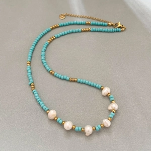 Handmade beaded necklace with blue seeds, gold spacers and freshwater pearls for women