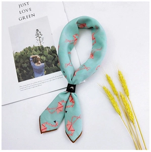 Detail of mint green cotton linen scarf with pink crane pattern and leather ring buckle