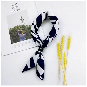 Detail of geometric blue and white scarf with leather buckle on lifestyle background