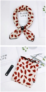 Detail of heart print cotton linen scarf with black leather ring and rivet buckle
