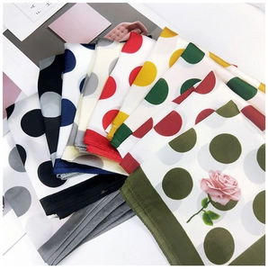 Polka dot silk scarves in various colors with floral details and smooth texture