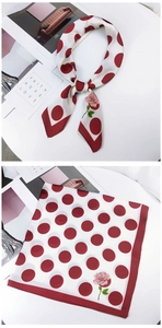 Detailed view of red polka dot scarf featuring pink rose prints and delicate hemmed edges