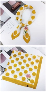 Detail of square silk scarf with yellow polka dots and pink rose print on cream fabric