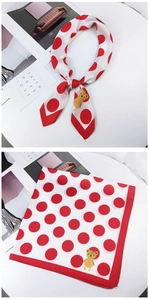 Detail of white silk scarf with red polka dots and cartoon bear illustration accents