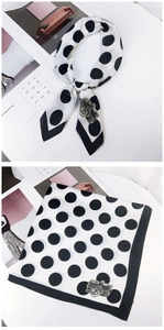Detail of polka dot square scarf with vintage camera print and black hemmed edges
