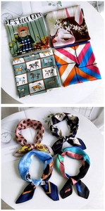 Detail view of cartoon pattern square silk scarves in assorted elegant prints