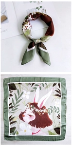 Detail showing cartoon rabbit girl illustration and floral pattern on square silk scarf