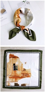 Detail of silk-texture square scarf with dark green borders and orange cat art pattern