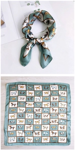 Detail of silk square scarf with horse print in sage green and caramel brown finish