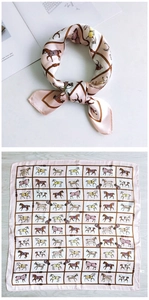 Detail of pink silk square scarf featuring equestrian horse prints and knotted styling