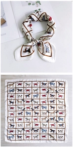 Detail of silk square scarf showing equestrian horse print and brown grid pattern layout