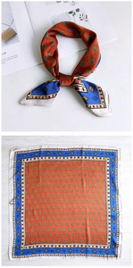 Detail of square silk scarf with green paisley print and blue geometric borders