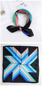 Detail of geometric stripe silk scarf with star pattern in blue and pink tones