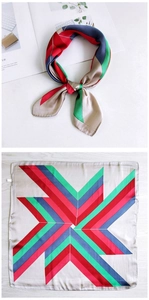 Detail view of square silk scarf showing geometric stripes and windmill pattern layout