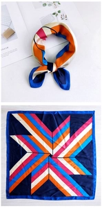 Detail view of square satin scarf showing multi-color geometric stripes and smooth texture