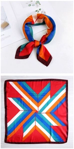 Detail of colorful geometric silk scarf showing multi-color pattern and stylish knot