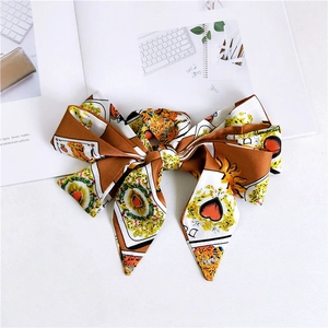 Detail of a large satin bow with poker card, heart, and tiger prints in vintage style