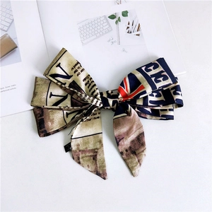 Vintage newspaper print hair ribbon with British flag pattern and textile label