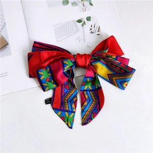Detail of colorful geometric pattern bow hair accessory on a fashion magazine
