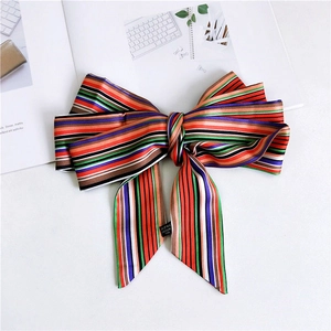 Detail view of 100% polyester satin narrow scarf with colorful vibrant stripes pattern