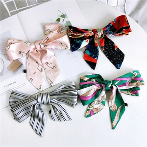 Set of four stylish satin bow hair ribbons with diverse floral and geometric patterns