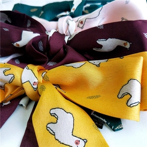 Satin skinny scarves with cartoon alpaca prints in yellow, red, pink, and green
