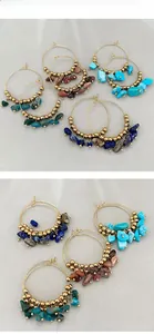 Detail view of Bohemian hoop earrings with assorted natural stones and gold metal beads